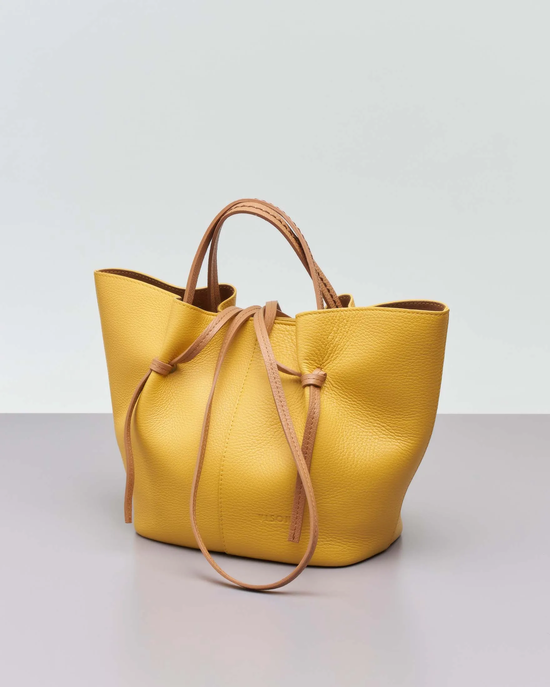 Borsa a mano gialla in pelle martellata con manici a contrasto e pochette color cuoio
