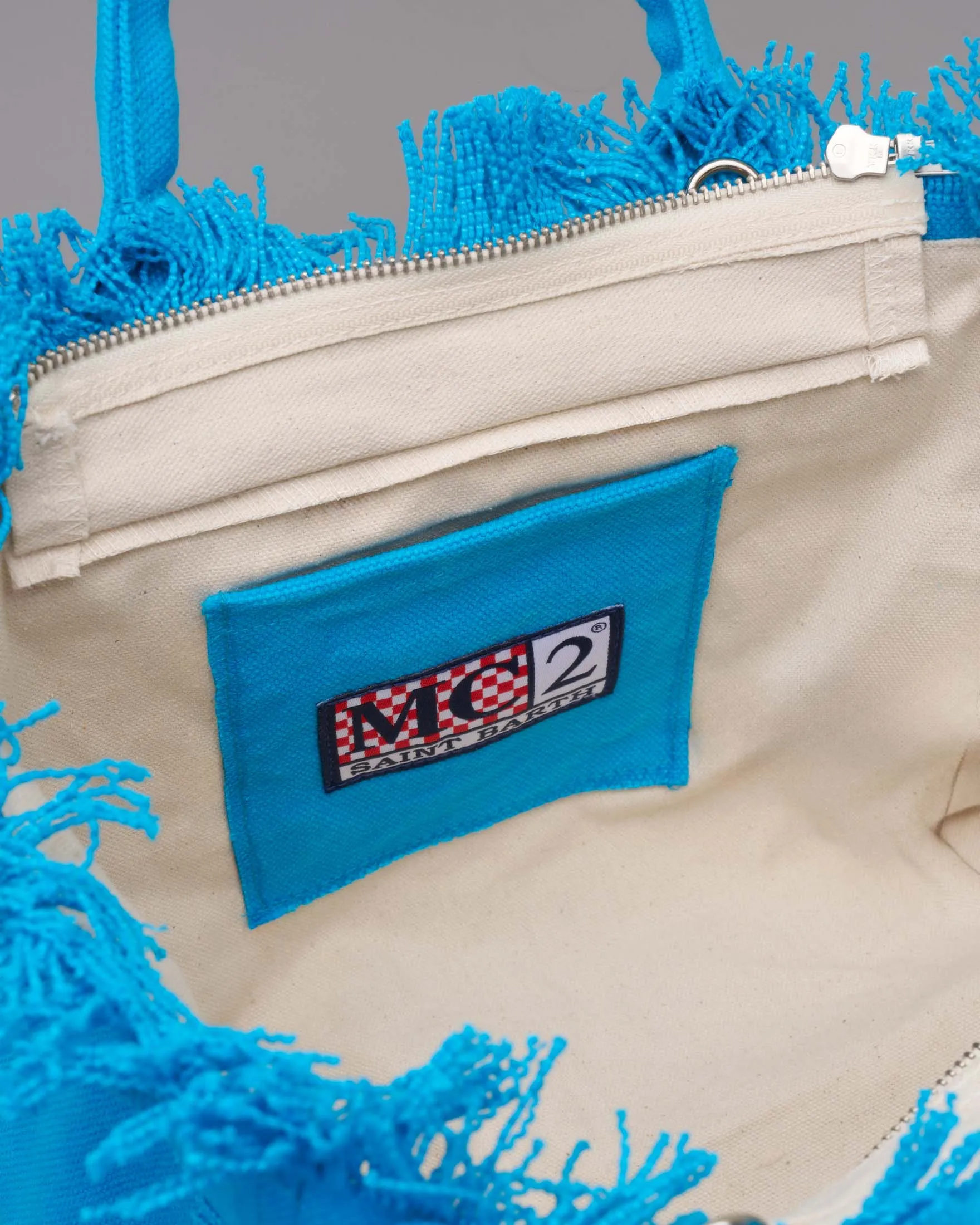 Borsa Colette turchese in cotone con logo rosa e orli sfrangiati