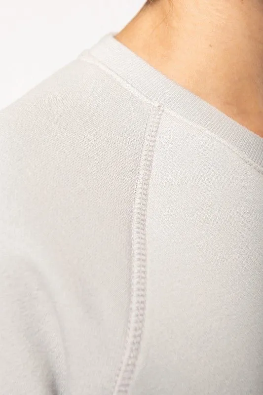 Felpa girocollo in cotone biologico con maniche raglan
